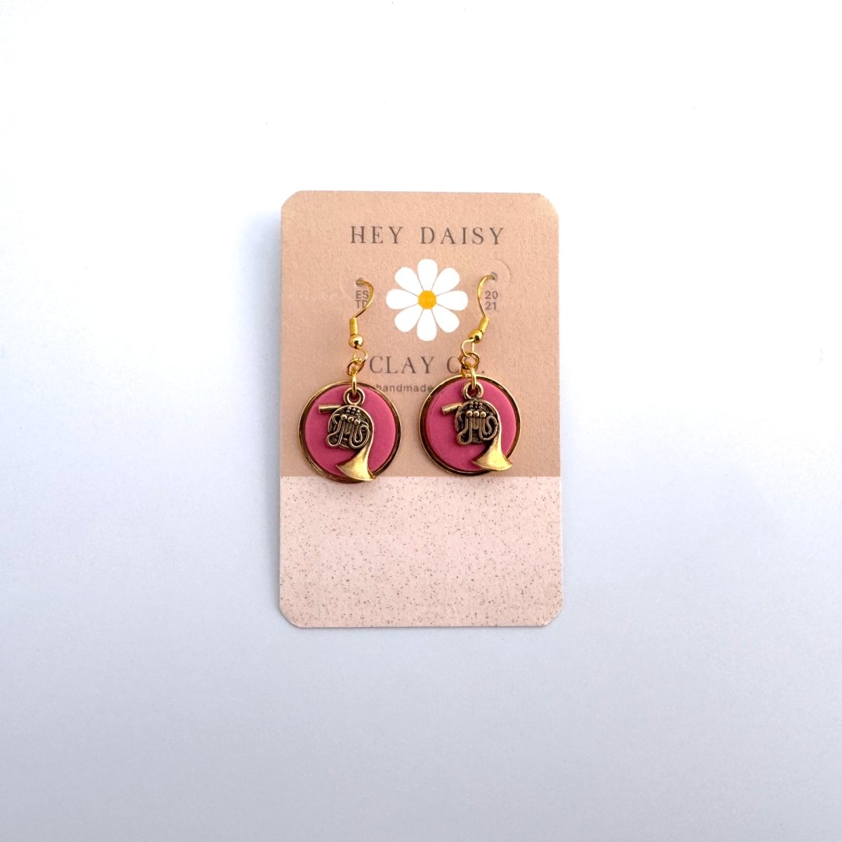 Gold horn earrings with pink backing